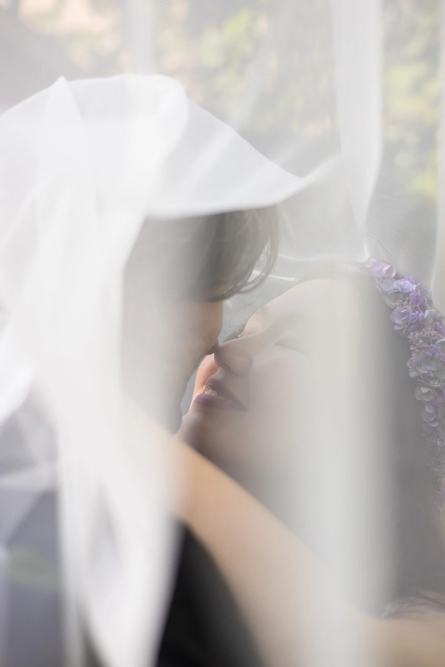 Bride and groom through veil