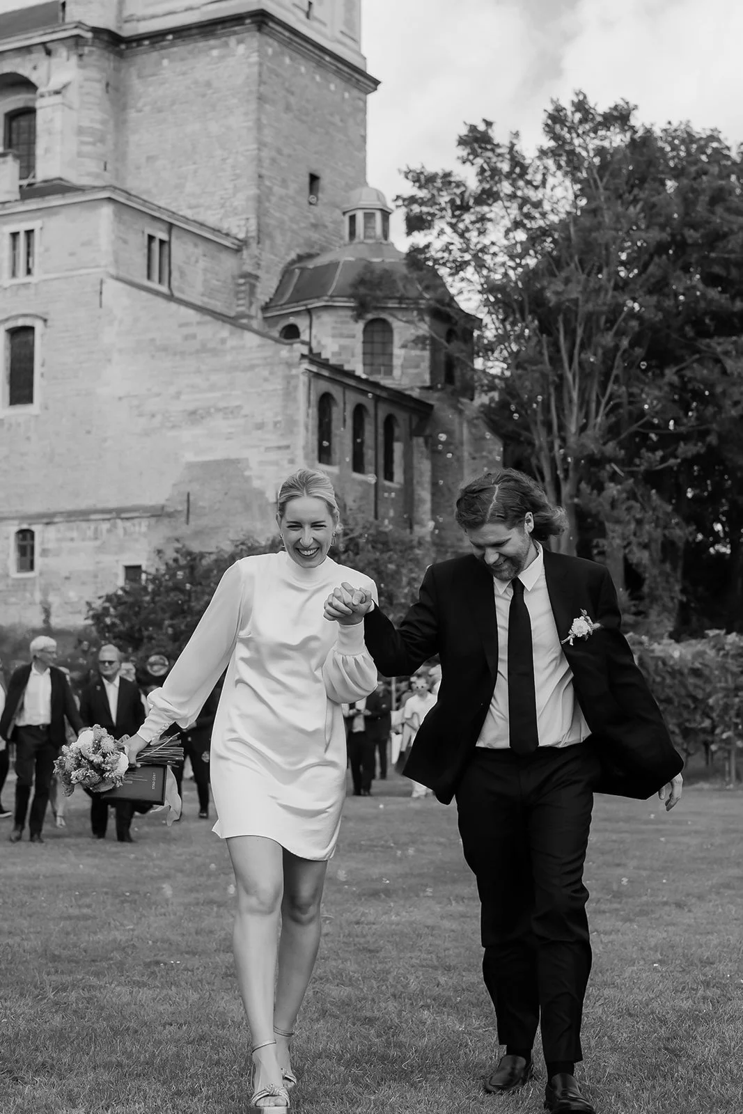 A newlywed couple walking out of their civil ceremony at Sint-Pietersabdij, Ghent, Belgium