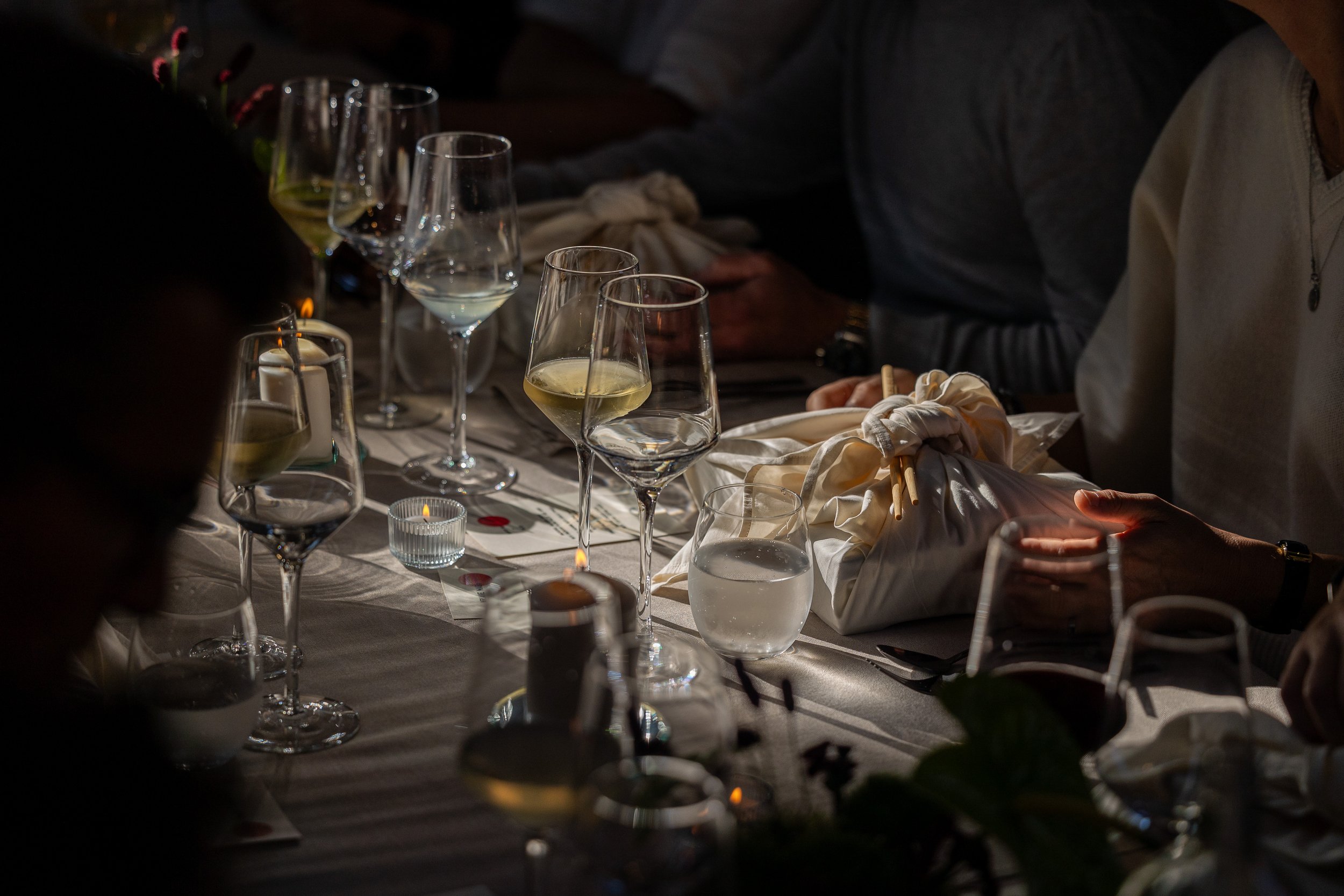 A table set with wine glasses, japanese sushi, at Hoeve De Vleug. Les Plumes Events and  Ceres Creative Events