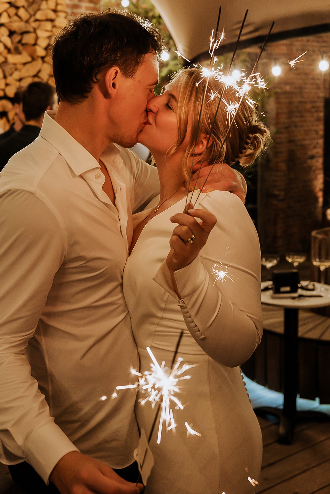 Bride and groom kissing, fire sparklers, Antwerp.
