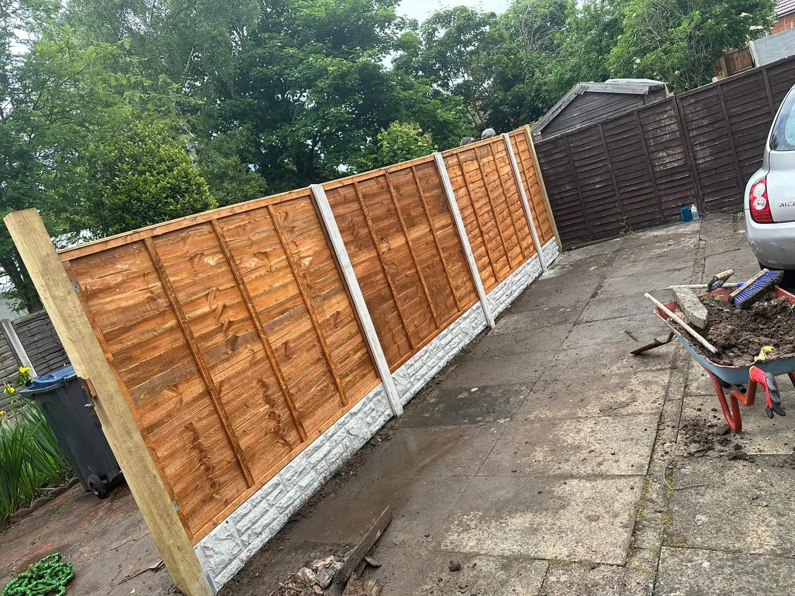 A newly built wooden garden fence with a side gate.