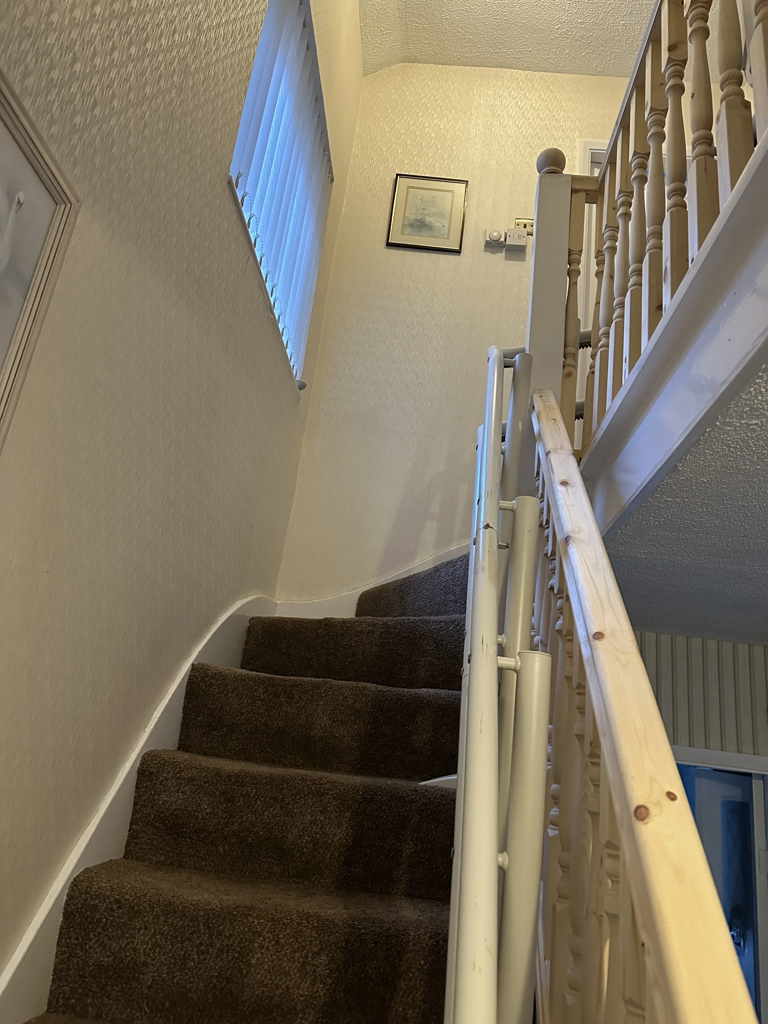 staircase with a wooden handrail and woodenBannister