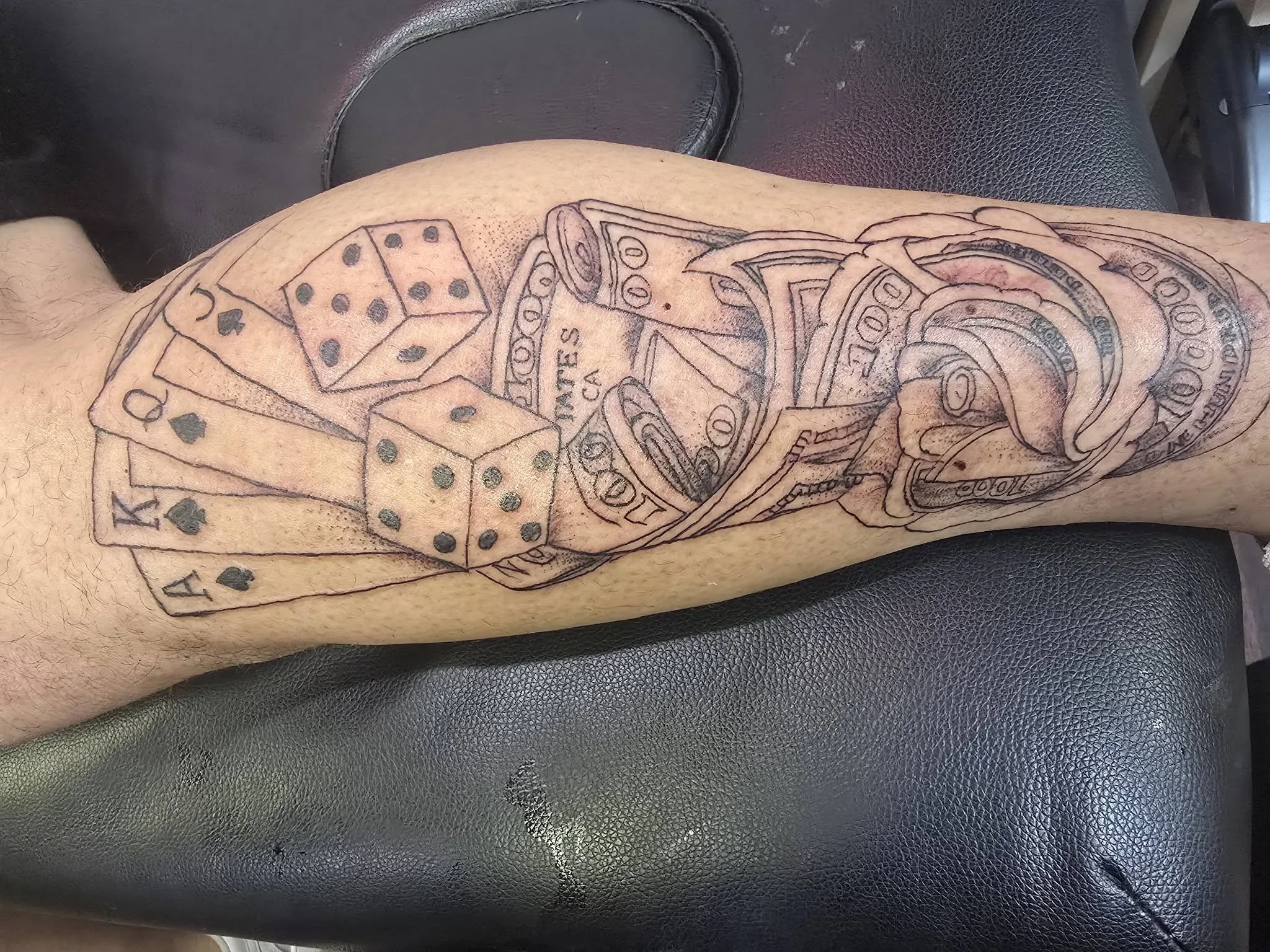 Tattoo on person's arm featuring dice, poker chips, money, and a poker hand with the text 'BET ON ME'.