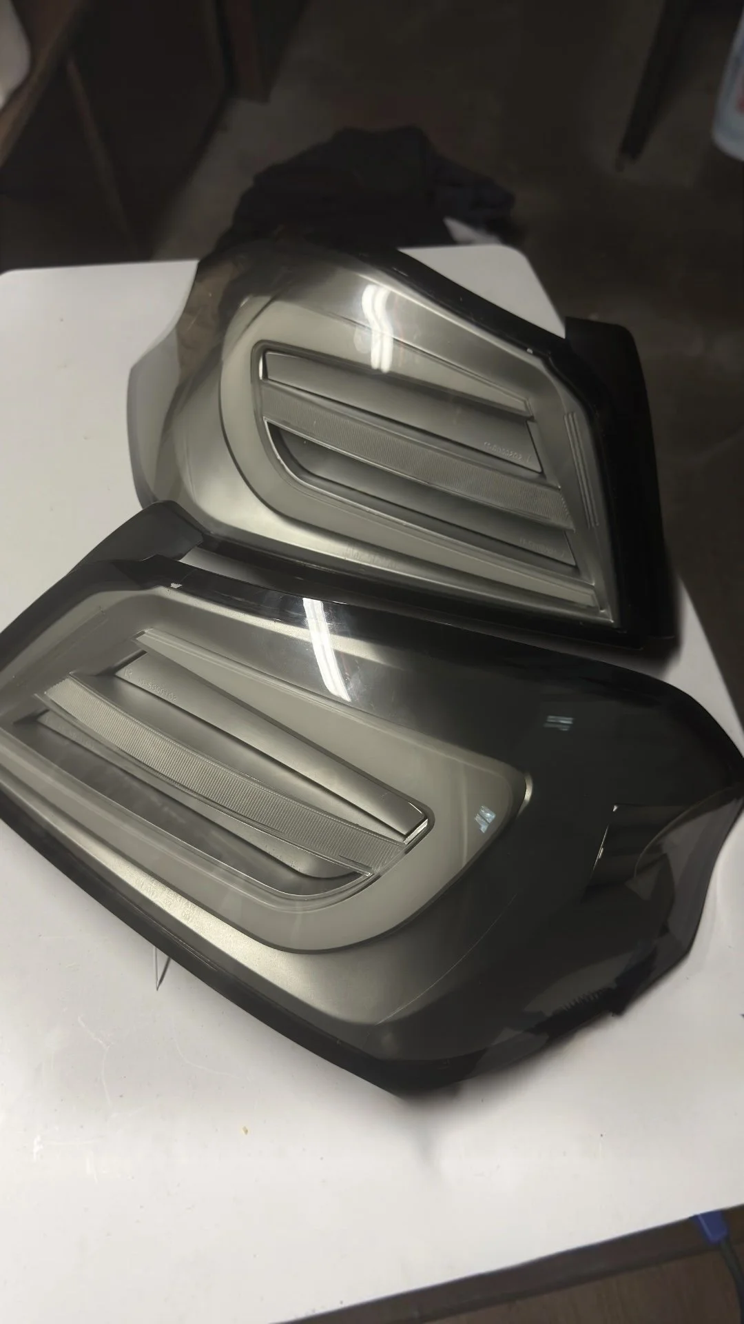 Two black and silver LED flashlight flashlights on a white surface.
