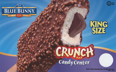 A Blue Bunny Crunch Bar with a king size label on blue background, partially bitten to show chocolate and marshmallow interior.