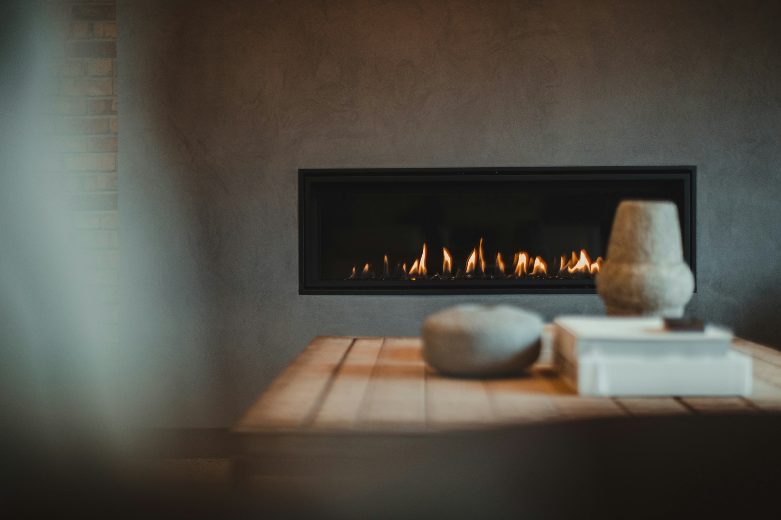 Modern linear gas fireplace with a ribbon of flame in a contemporary home