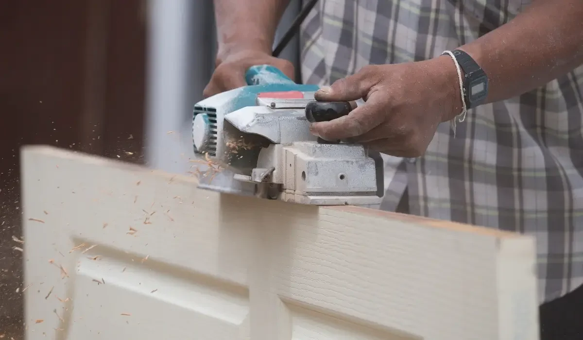 Planing the edge of a door that sticks in its frame