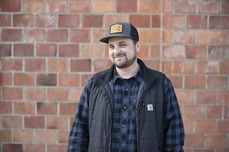 Mark outdoors in front of a brick wall