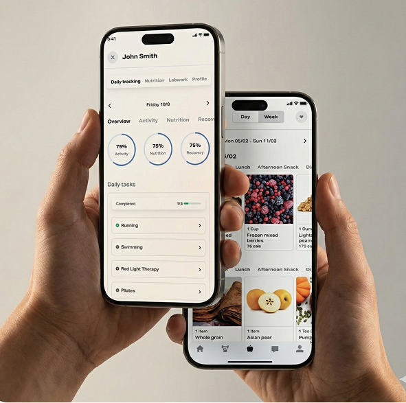 Two hands holding smartphones displaying health and meal tracking apps.