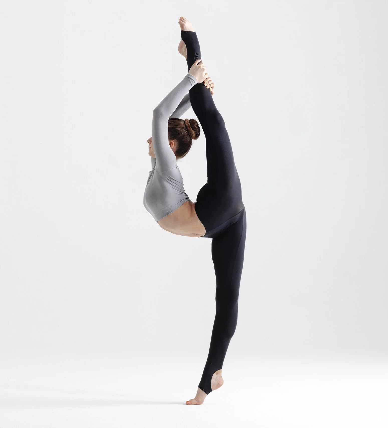 Rhythmic gymnast demonstrating flexibility with a standing split position.