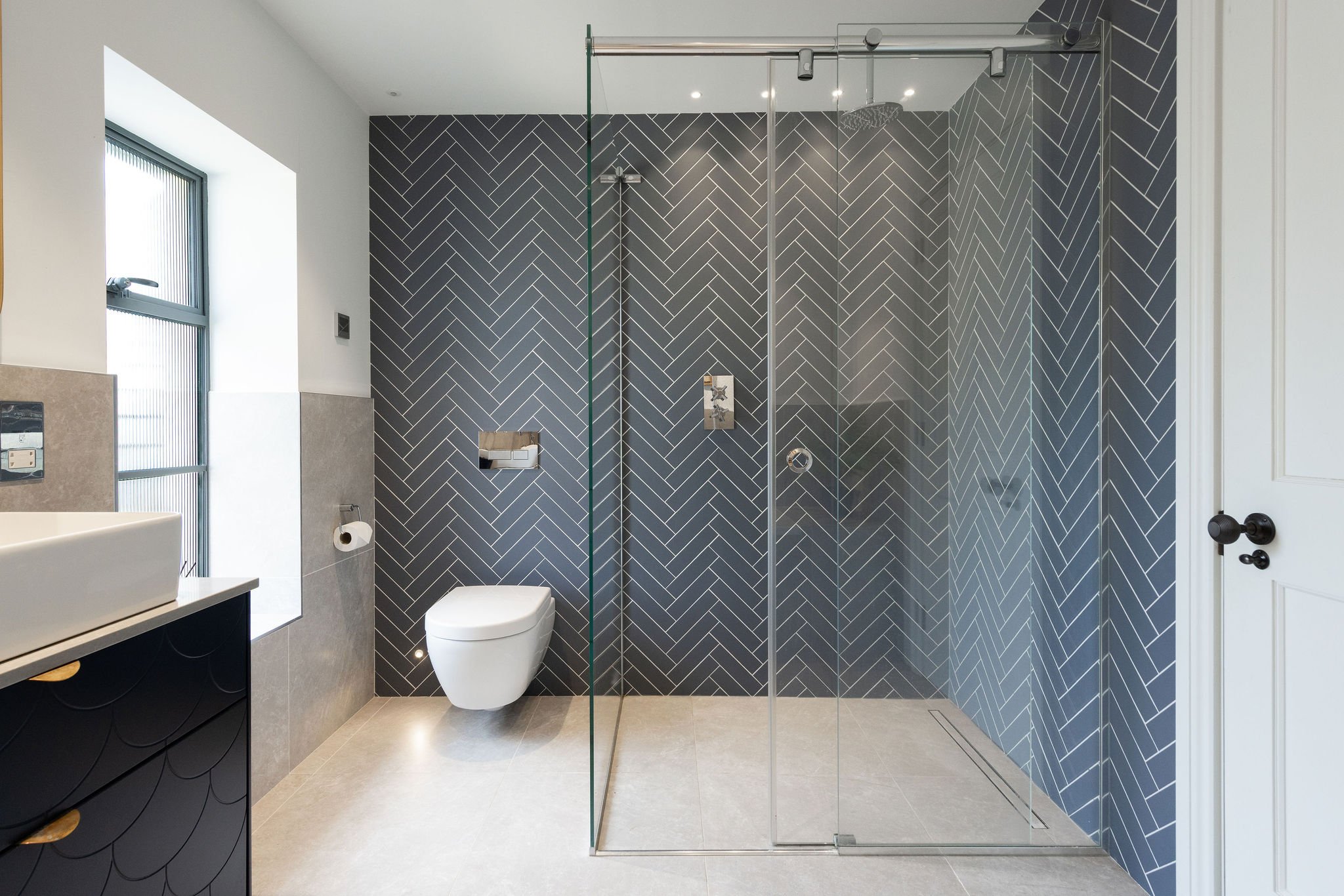 modern-en-suite-herringbone-tile-walk-in-shower-birdham.jpg