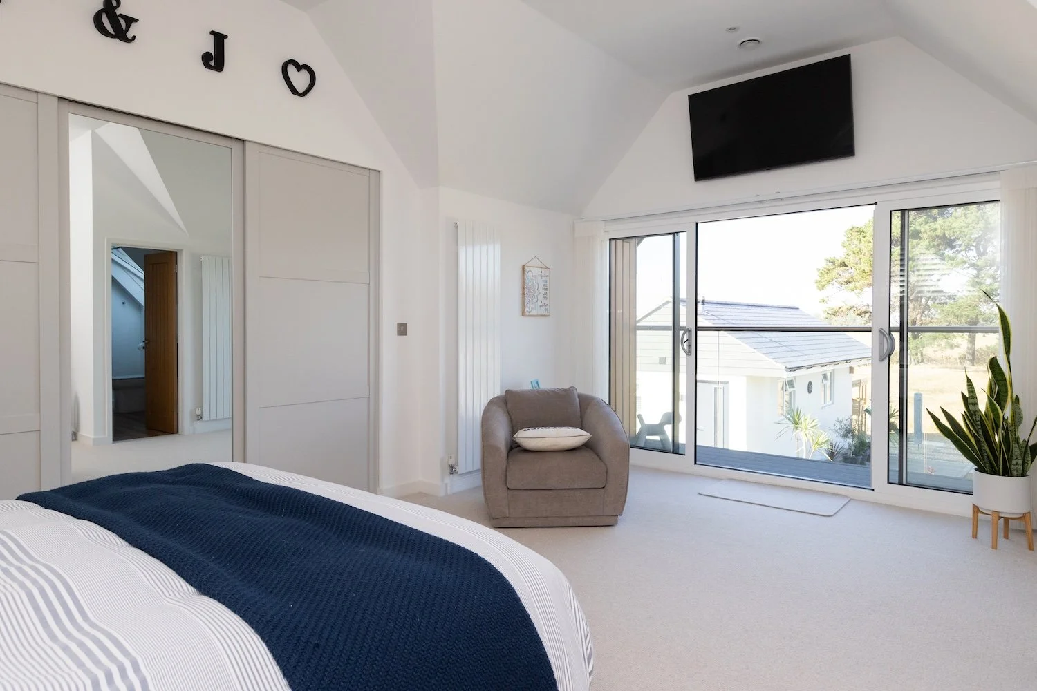 vaulted-master-bedroom-sliding-doors-balcony-selsey.jpg