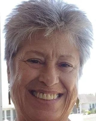 Close-up of smiling older woman with short gray hair