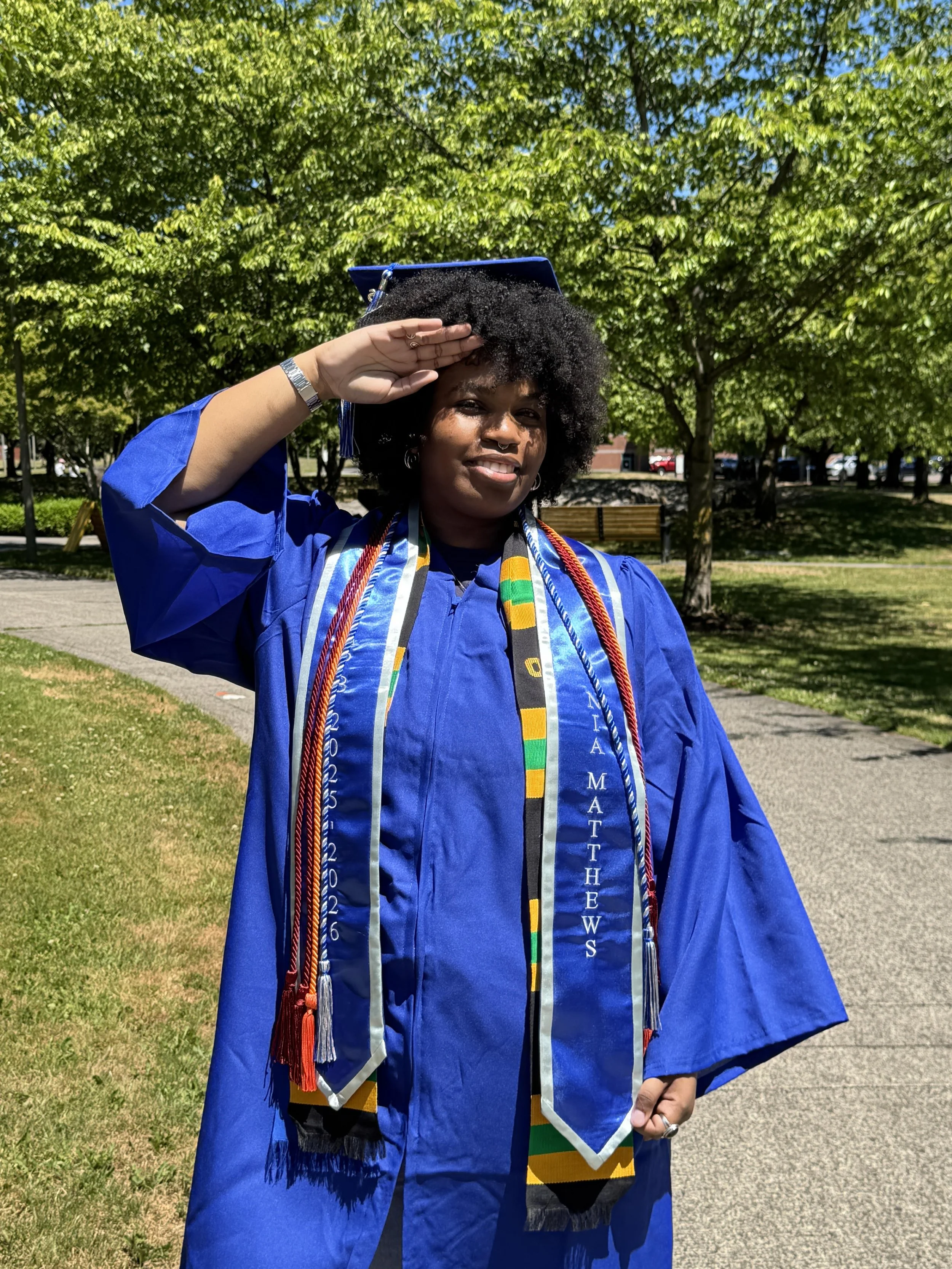 A picture of Nia in their cap and gown.