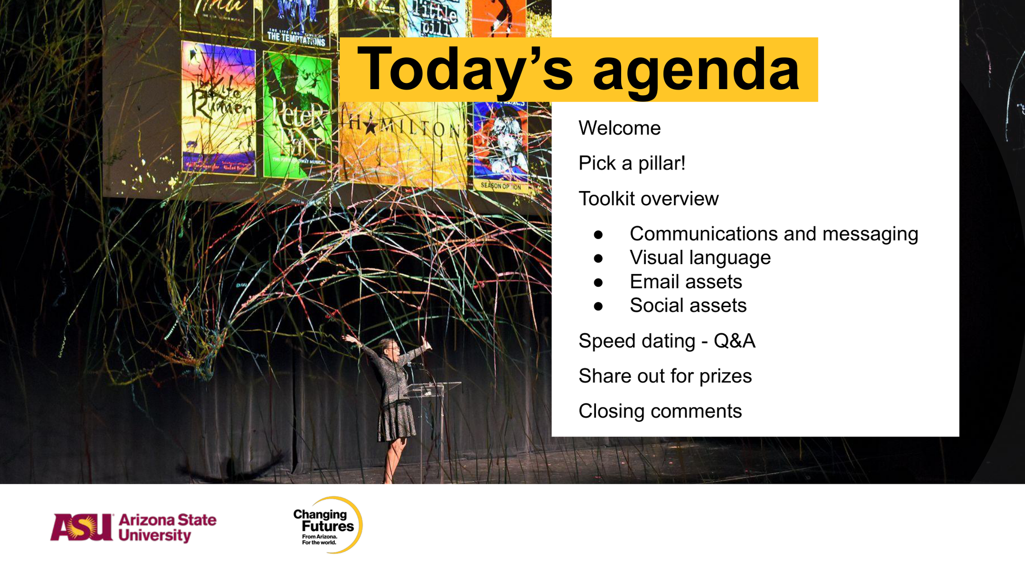 A presentation slide titled 'Today's agenda' with a list of scheduled topics, including welcome, pick a pillar, toolkit overview, speed dating Q&A, sharing for prizes, and closing comments. In the background, a woman in a dress is speaking at a podium on stage, with colorful streamers and banners for theater productions displayed above.