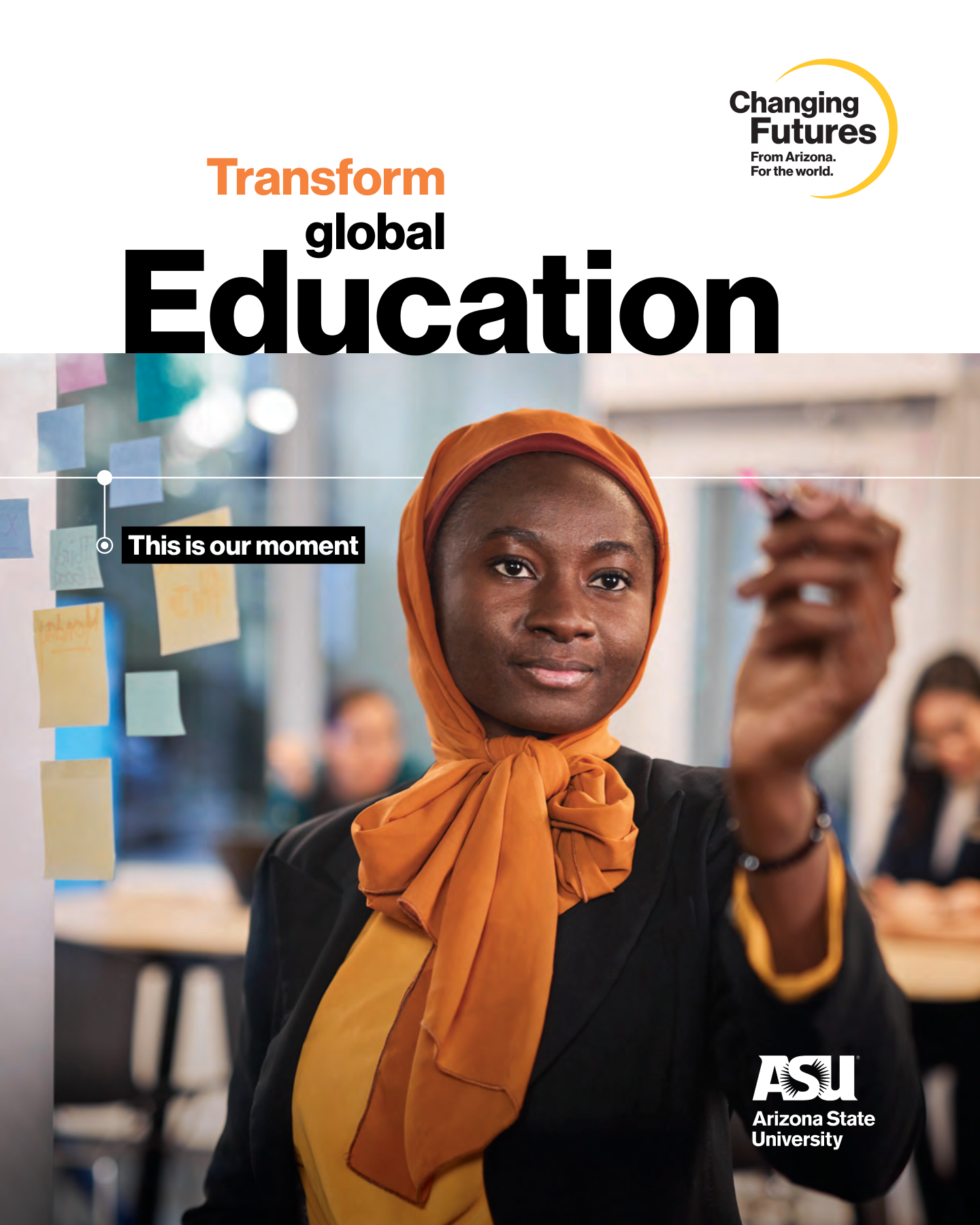 A woman wearing an orange headscarf and a black blazer, raising her hand during a meeting or class with sticky notes on a glass wall in the background, at Arizona State University.