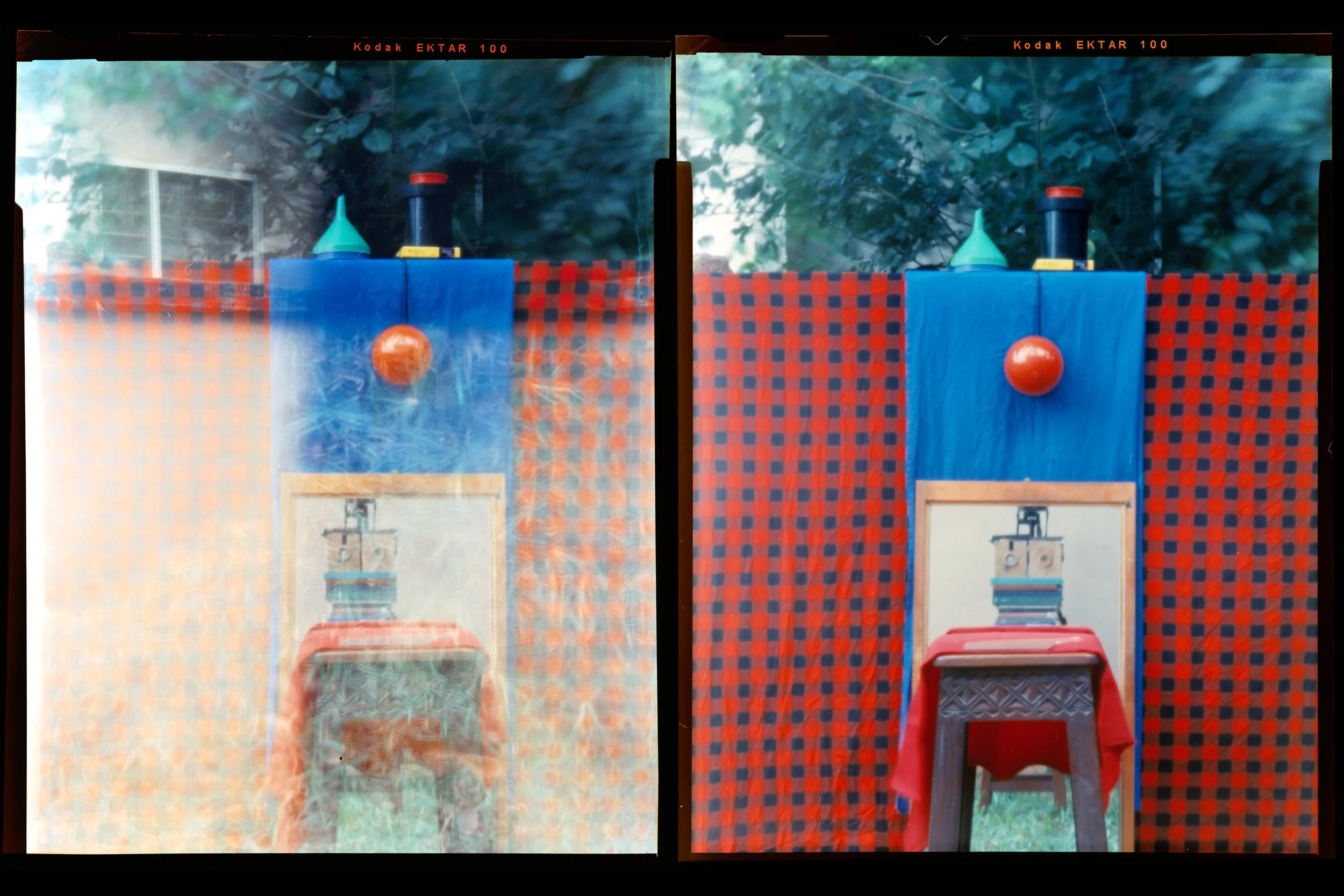 Two photographs side by side showing similar views of a wooden stool, a mirror reflecting two wooden pinhole cameras, against a backdrop of a red circular object on a blue cloth over a checkered red cloth, with foliage in the background.