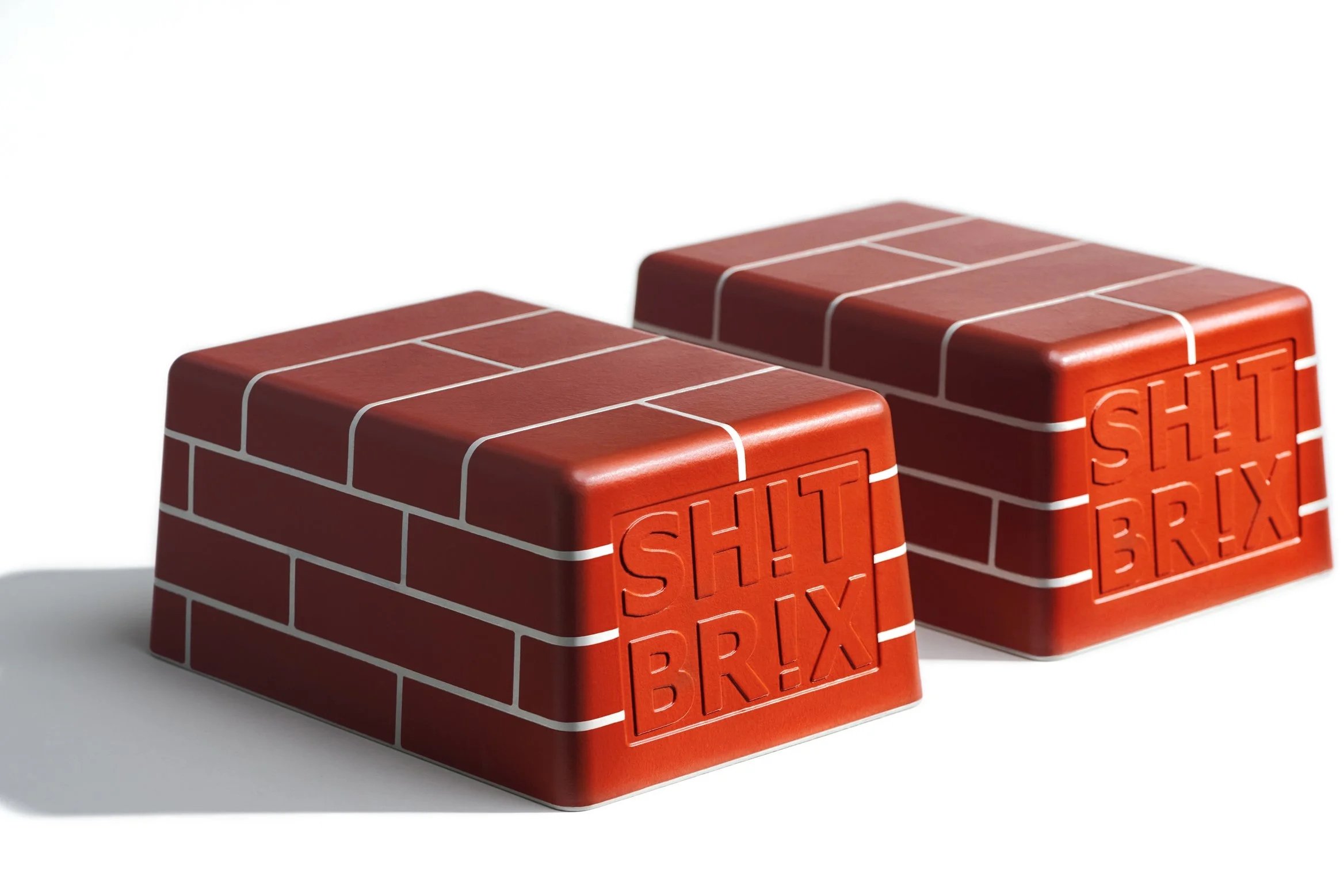 SH!T BR!X modular red brick-style toilet stool footrests, pair shown with embossed branding