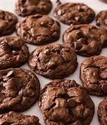 Close-up of several chocolate chip cookies on a white background.