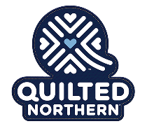 Logo of Quilted Northern featuring a stylized quilt pattern and a small heart in the center.