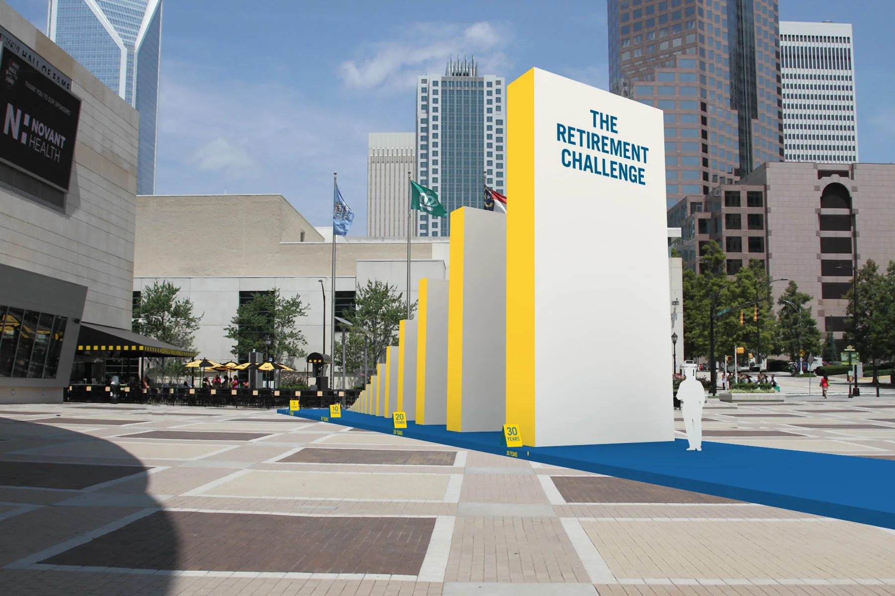 A large white display with yellow edges titled 'The Retirement Challenge' in an urban plaza with skyscrapers in the background, flags, trees, and outdoor seating.