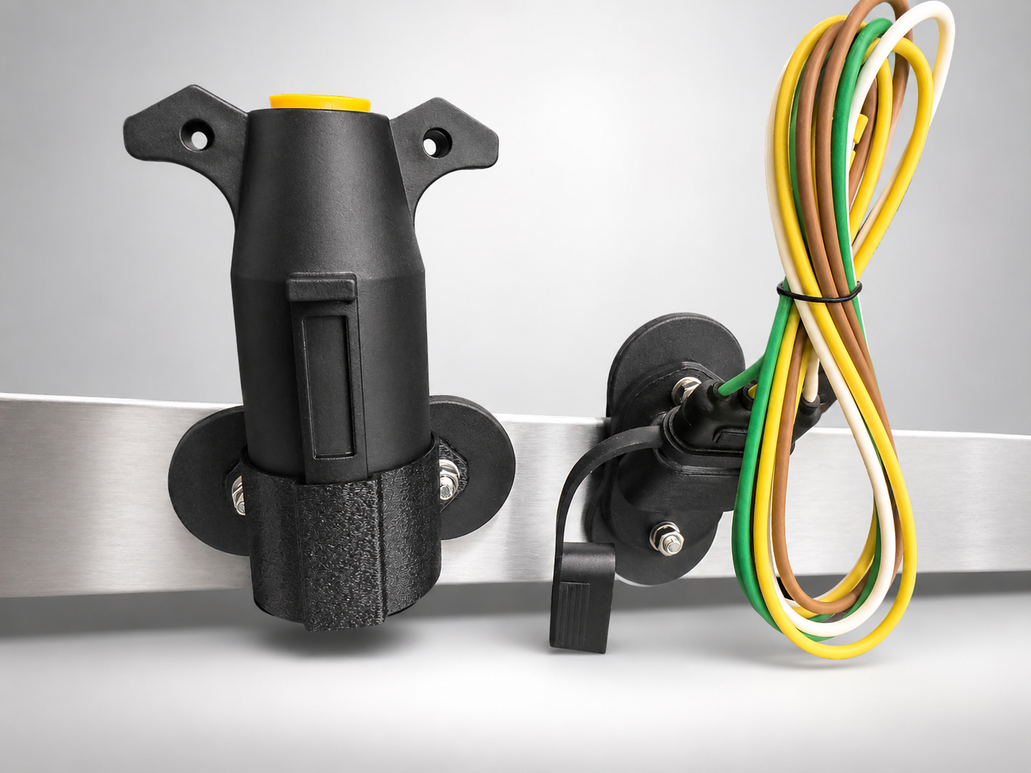 Electrical components including a black socket, a bundle of colored wires, and a metallic mounting rail.