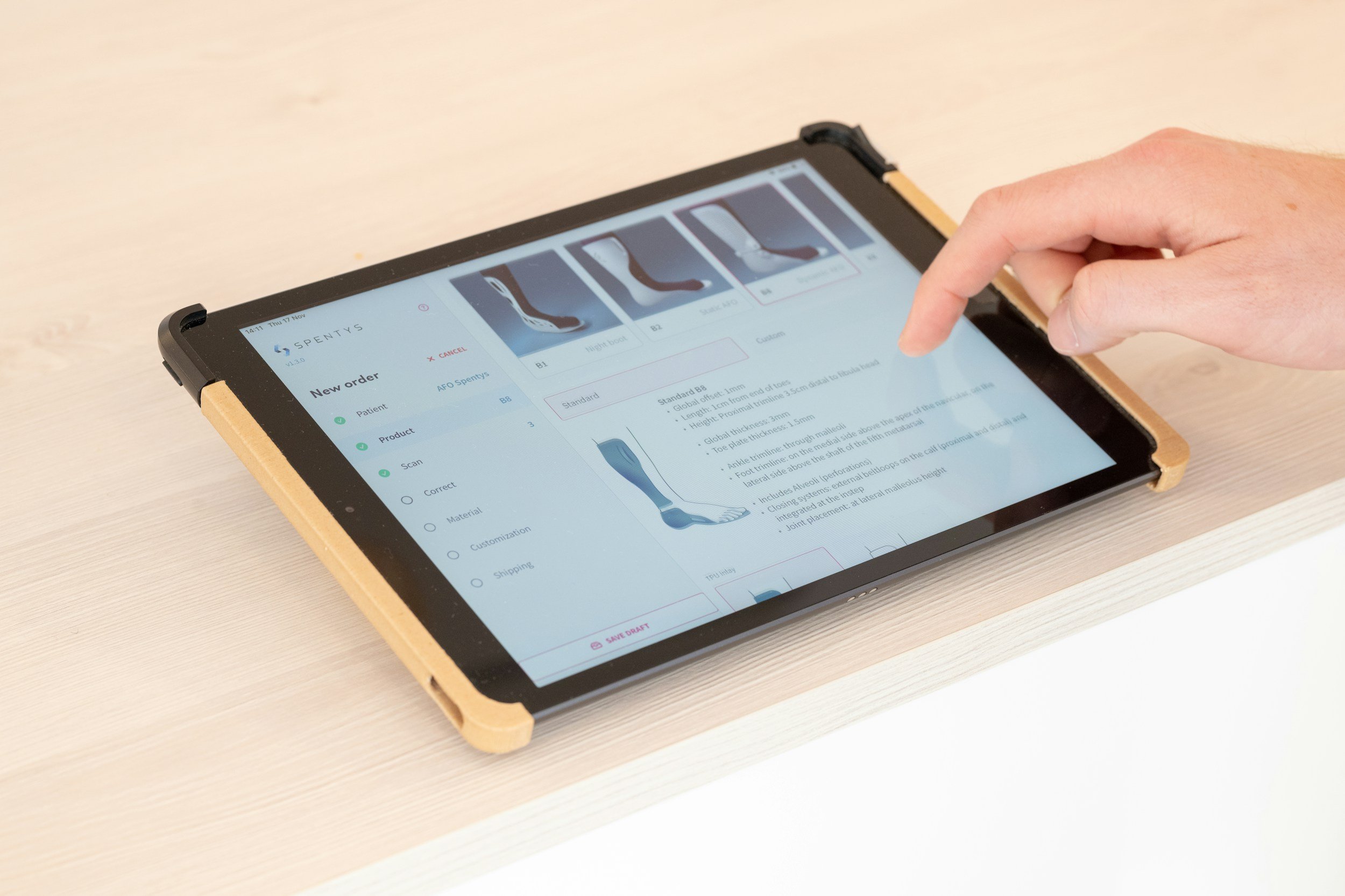 Medical software  and 3d scanning with images of a foot and options for ordering custom orthotics on a white table.