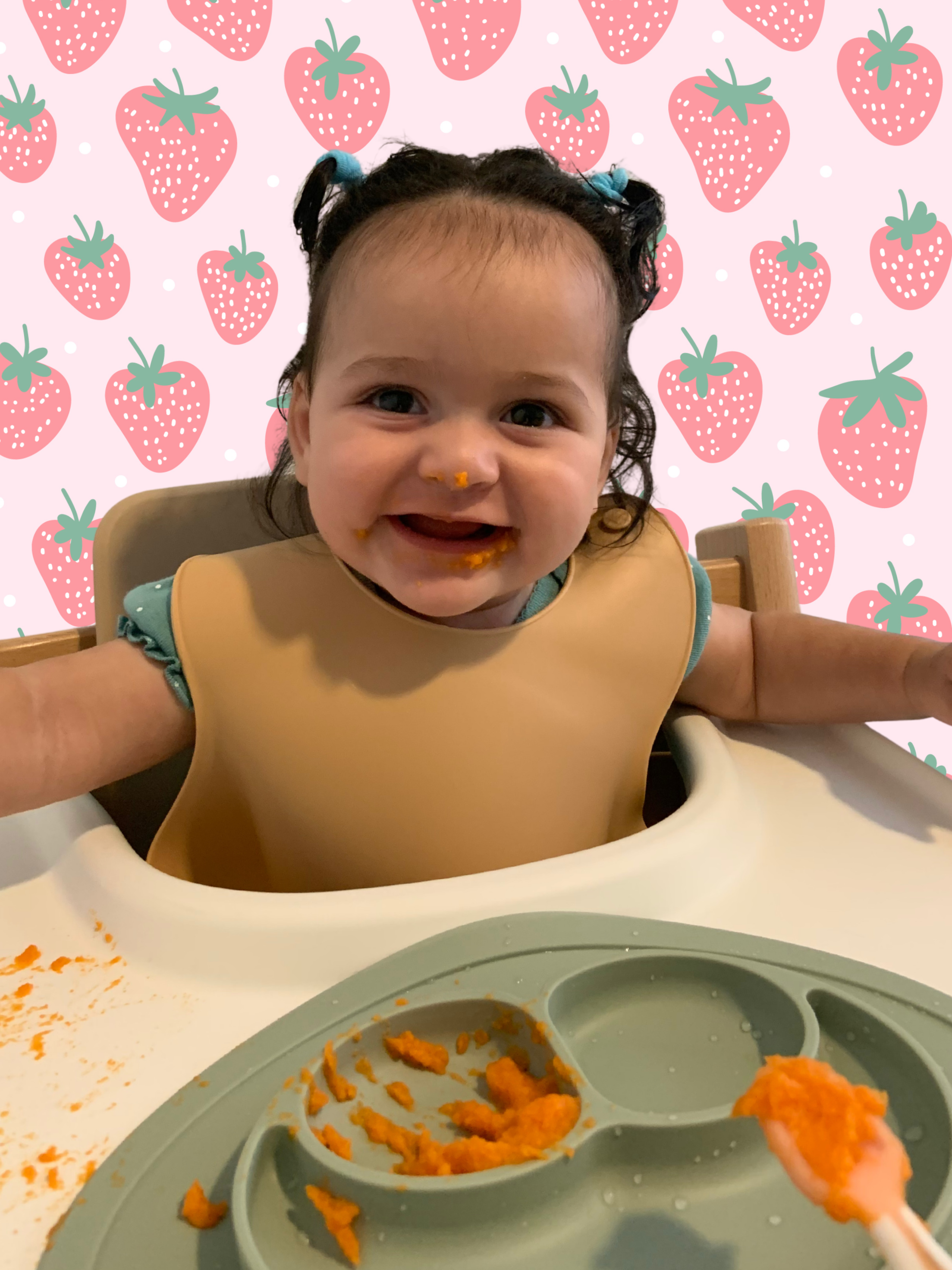 happy baby smiling while eating a bright orange puree, gootensil with puree, ezpz suction bowl