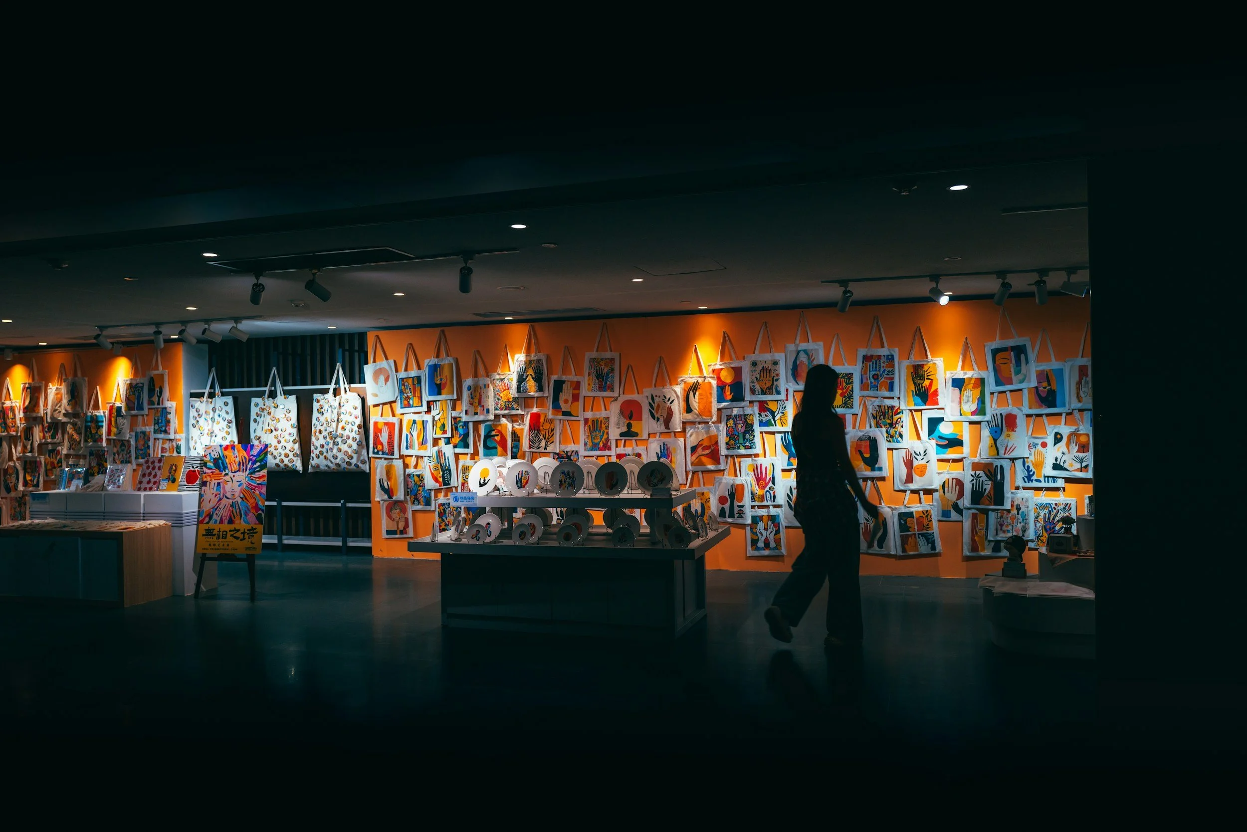 Visitors exploring a colorful art exhibition. Stock image representing upcoming art shows.