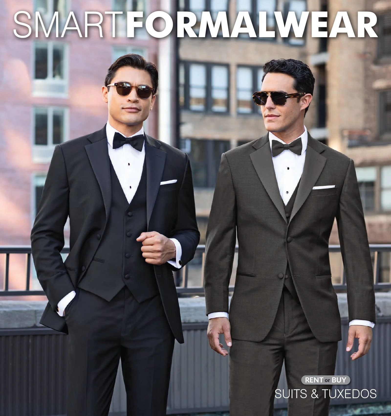 Two men dressed in tuxedos with bow ties and sunglasses standing outdoors in front of a building with large windows.