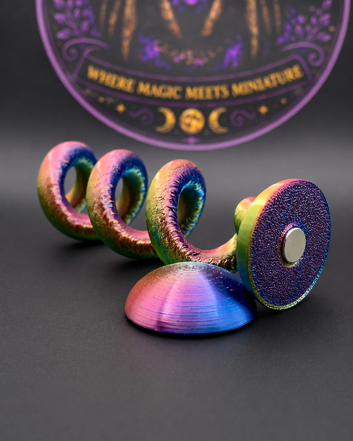 The Spiral Perch 3D printed jumping spider enclosure accessory shown with its removable magnetic mounting pieces.
