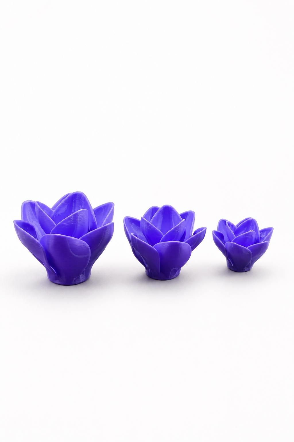 Small, medium and large purple 3D printed Moonbloom flower hides with layered petals for jumping spider enclosures.