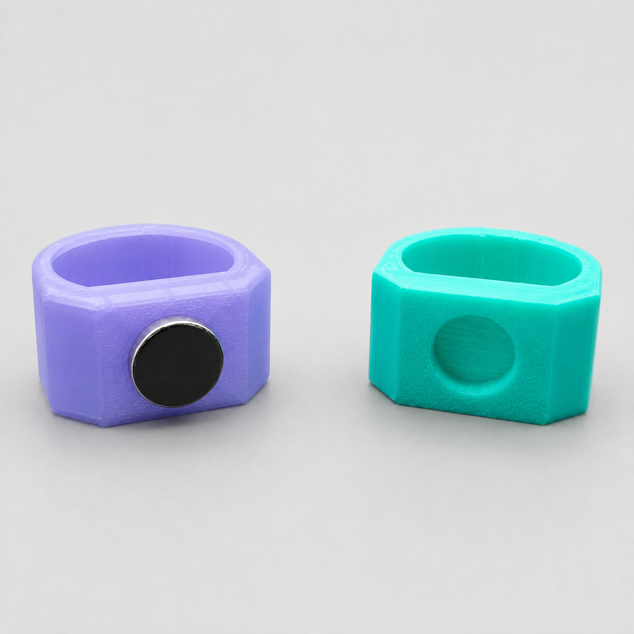 Back view of purple and teal 3D printed Feeding Nooks showing magnetic and non-magnetic mounting options for jumping spider enclosures.