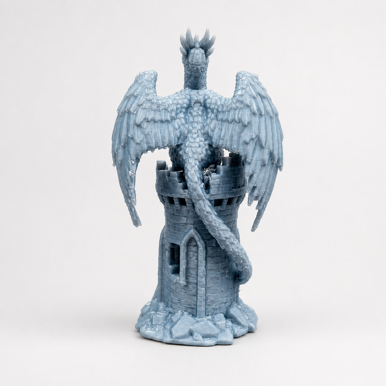 Back view of The Phoenix’s Roost miniature 3D printed fantasy tower showing the firebird’s large wings and detailed tail.