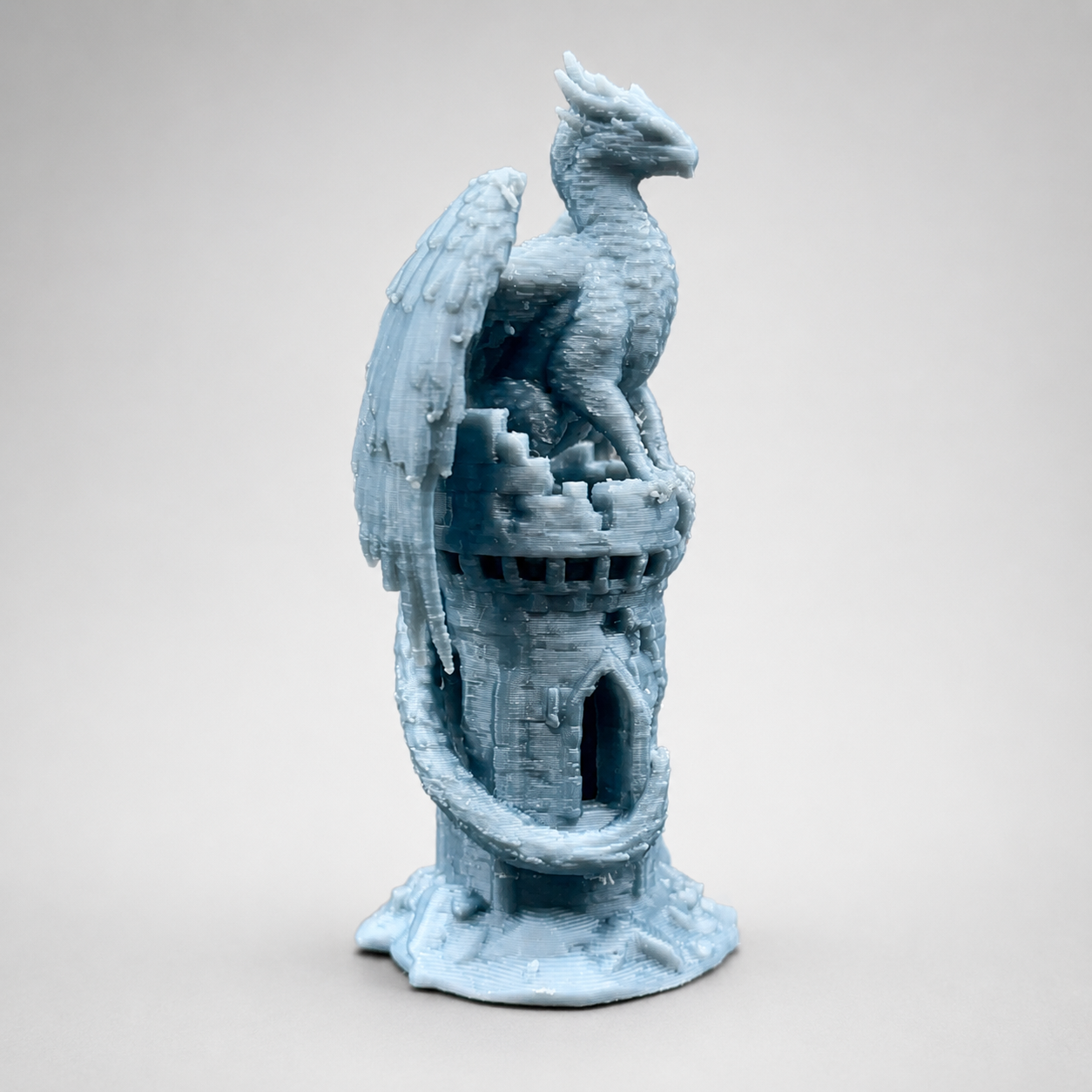 Side view of The Phoenix’s Roost showing a 3D printed phoenix-like firebird, castle tower, arched openings and sweeping tail.