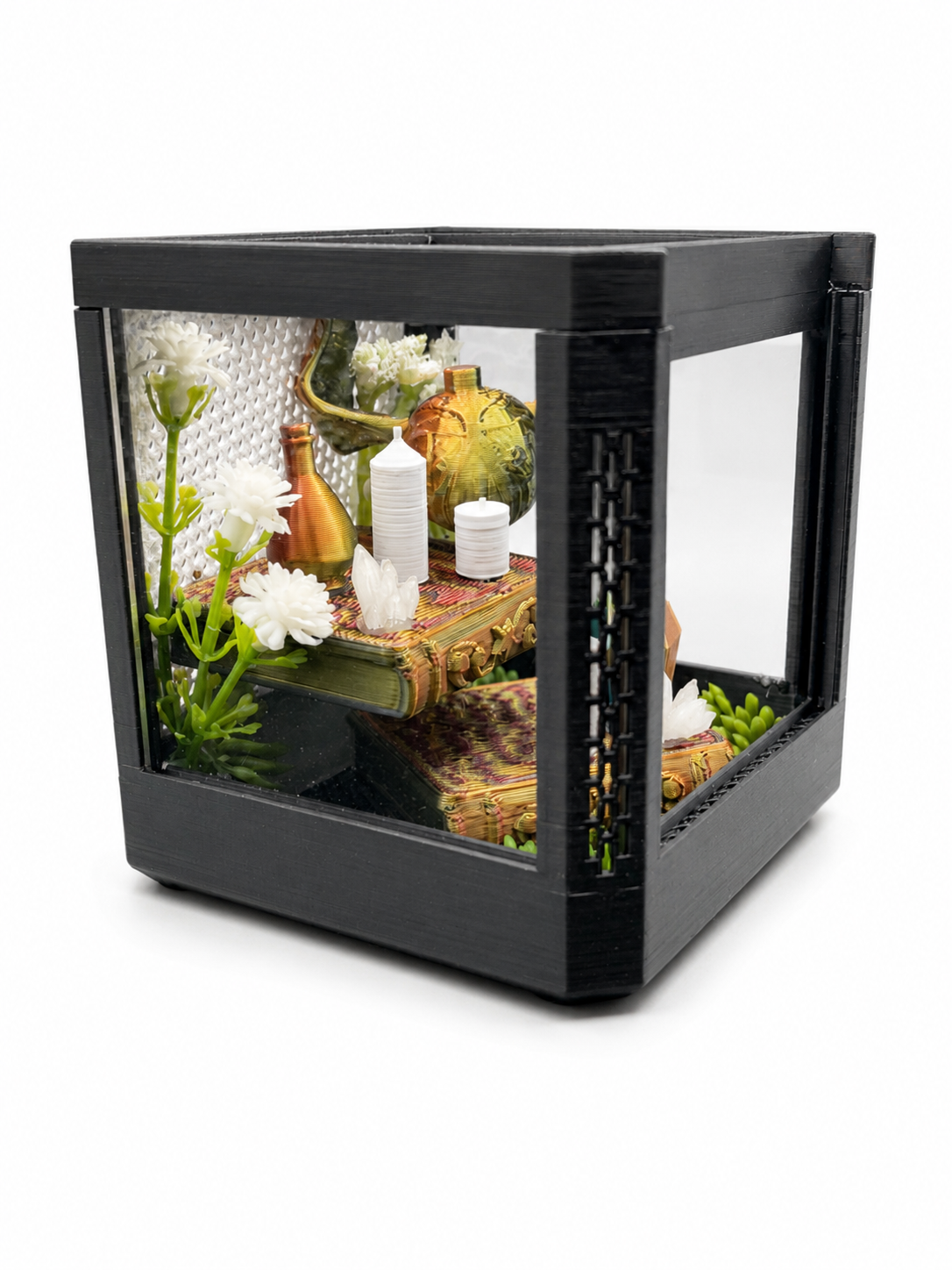 Side view of a magical library themed decorated jumping spider enclosure with miniature spellbooks, potion bottles and plants.