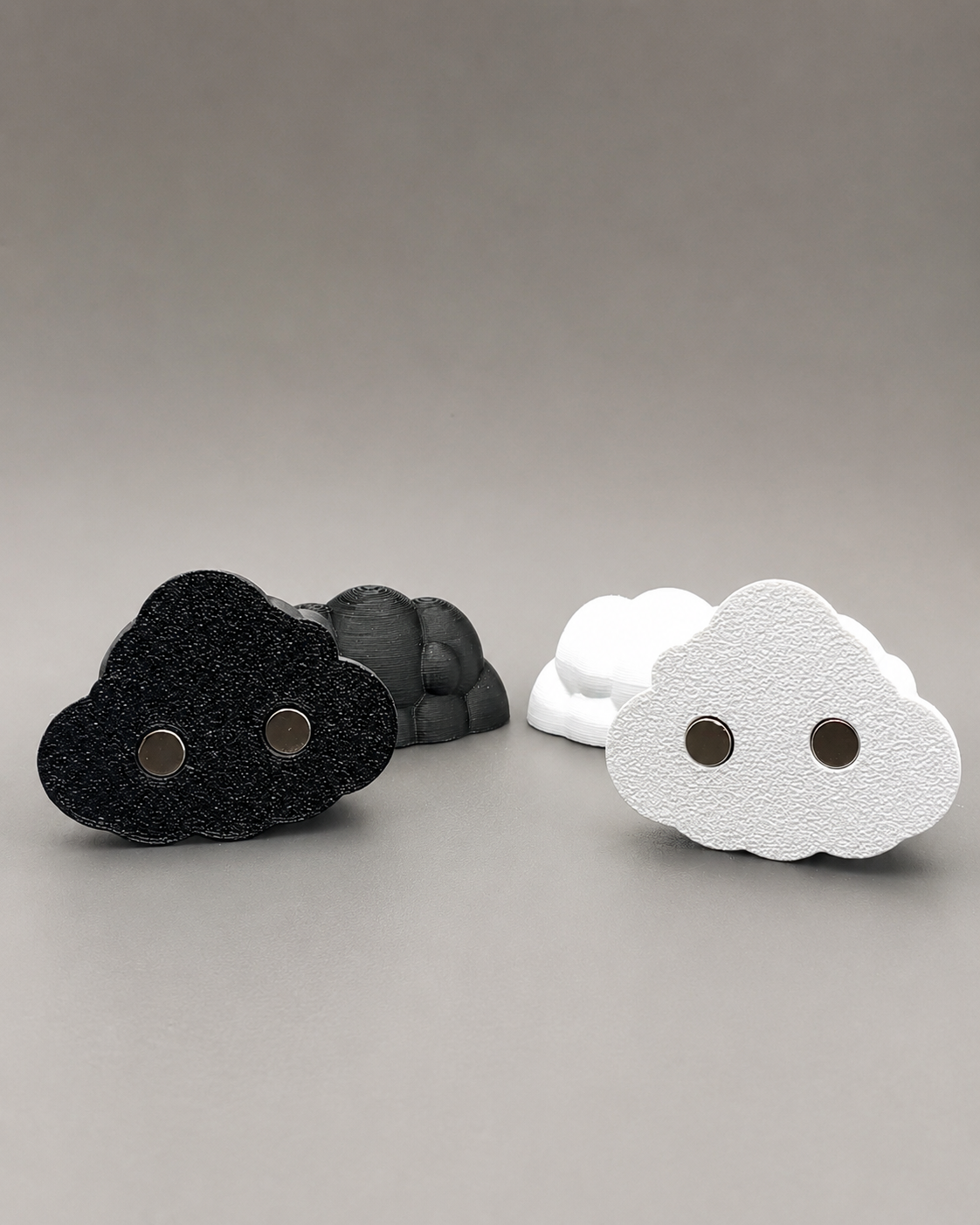 Set of two black and white Fluffy Cloud Ledges with embedded magnets for mounting inside a jumping spider enclosure.