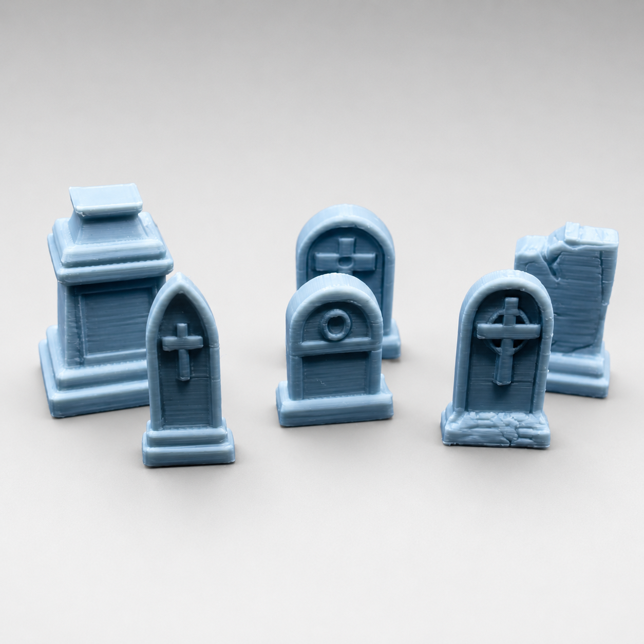 Front view of the Tiny Graveyard Set featuring six different 3D printed tombstones for a miniature jumping spider enclosure cemetery.
