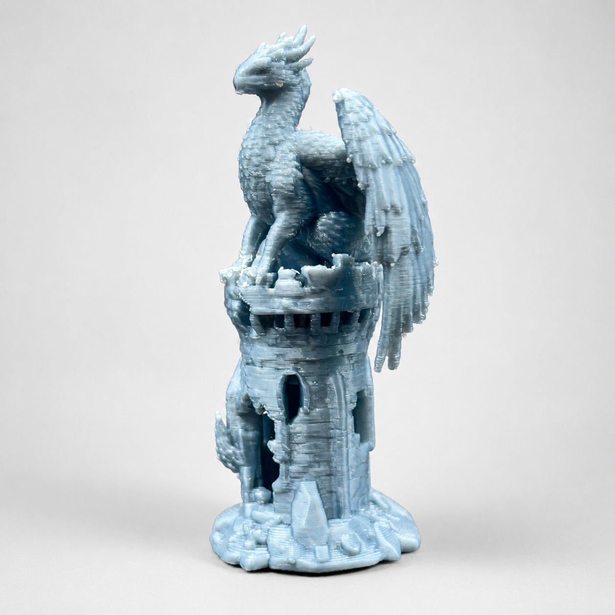 Miniature blue 3D printed Phoenix’s Roost with a winged firebird perched on a fantasy tower for jumping spider enclosure decor.