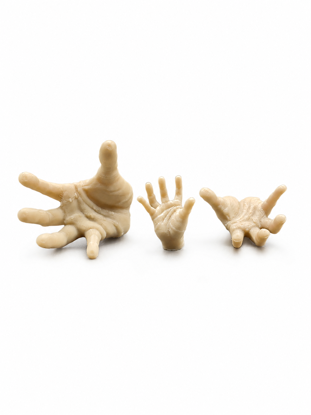Three sizes of 3D printed miniature creeping hand decor shown palm-up for gothic jumping spider enclosures and witchy miniature scenes.