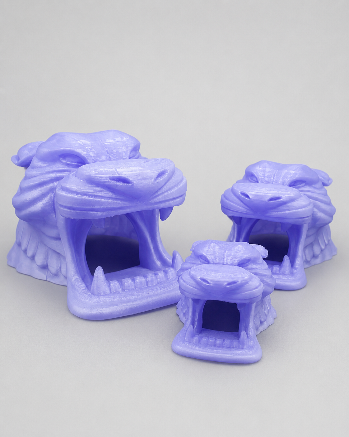 Purple Hidden Treasure Cave 3D printed enclosure hides in three sizes with sculpted eyes, fangs and dramatic cave entrances.