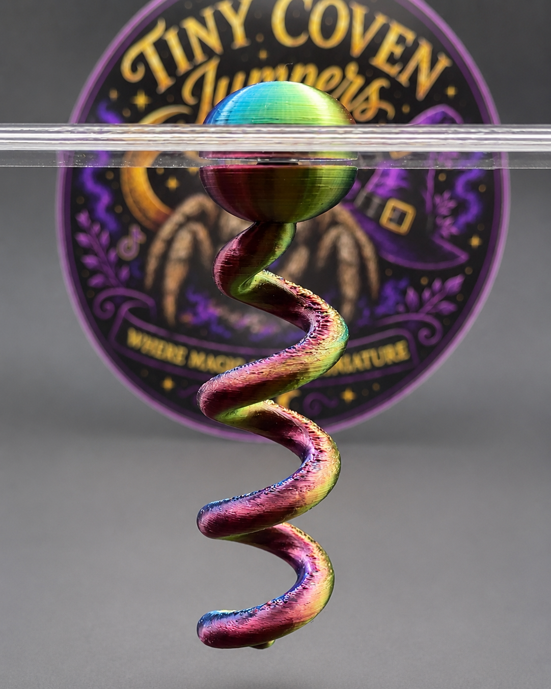 Color-shifting Spiral Perch magnetically mounted from the top of a jumping spider enclosure for vertical climbing and enrichment.