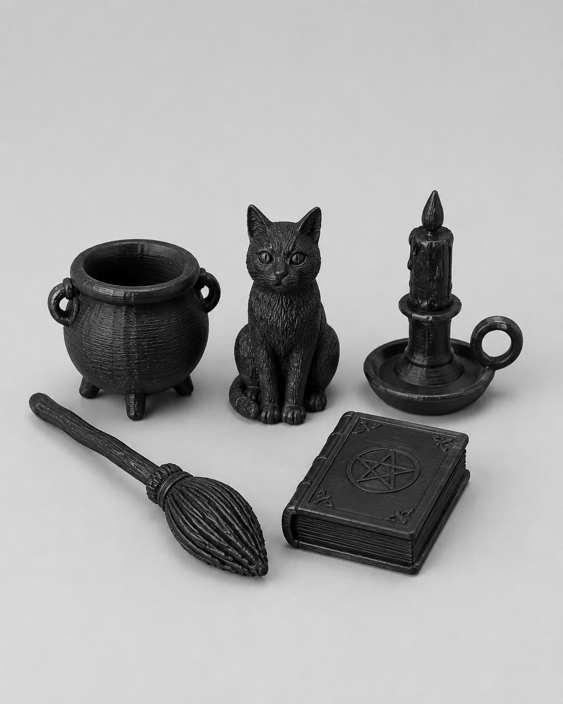 Detailed five-piece witchy miniature decor set with cauldron, cat familiar, candle, broom and spellbook for magical jumping spider enclosure scenes.