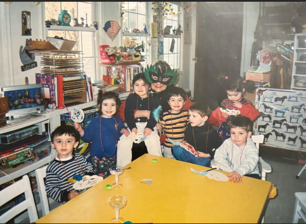 Children celebrating Halloween with masks, costumes, and party decorations in a room.
