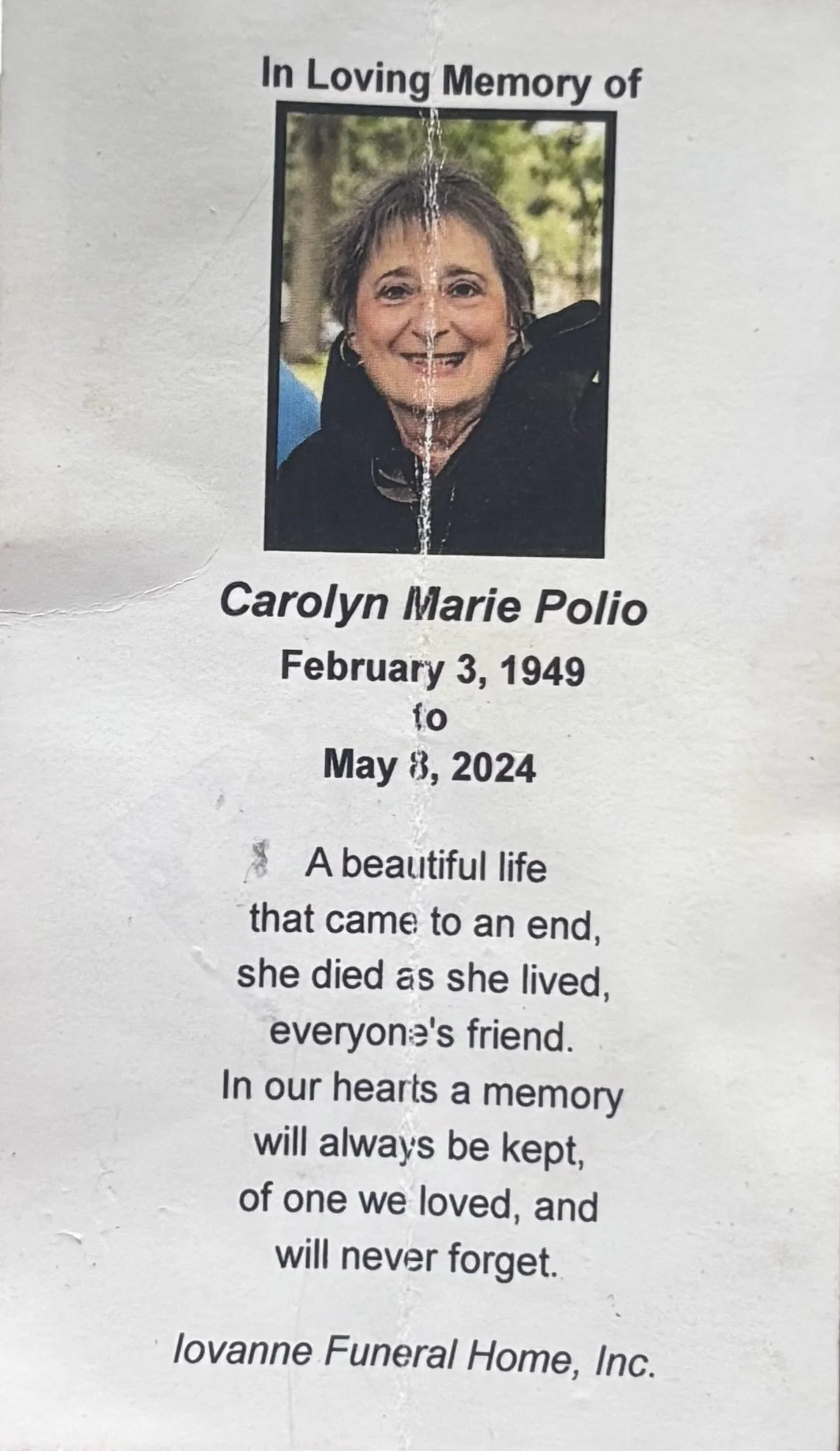 Memorial card with a photo of a woman smiling outdoors, with text in memory of Carolyn Marie Polio, who was born February 3, 1949, and passed away May 8, 2024. The card includes a message about her life and a mention of Iovanne Funeral Home, Inc.