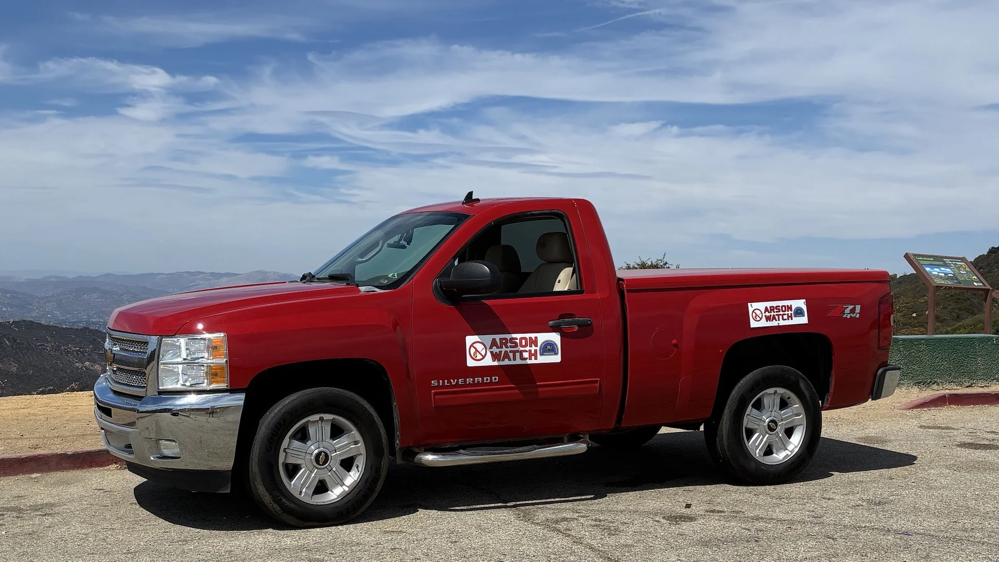 Red truck with Arson Watch signage on parked at Saddle Peak and Stunt Roads