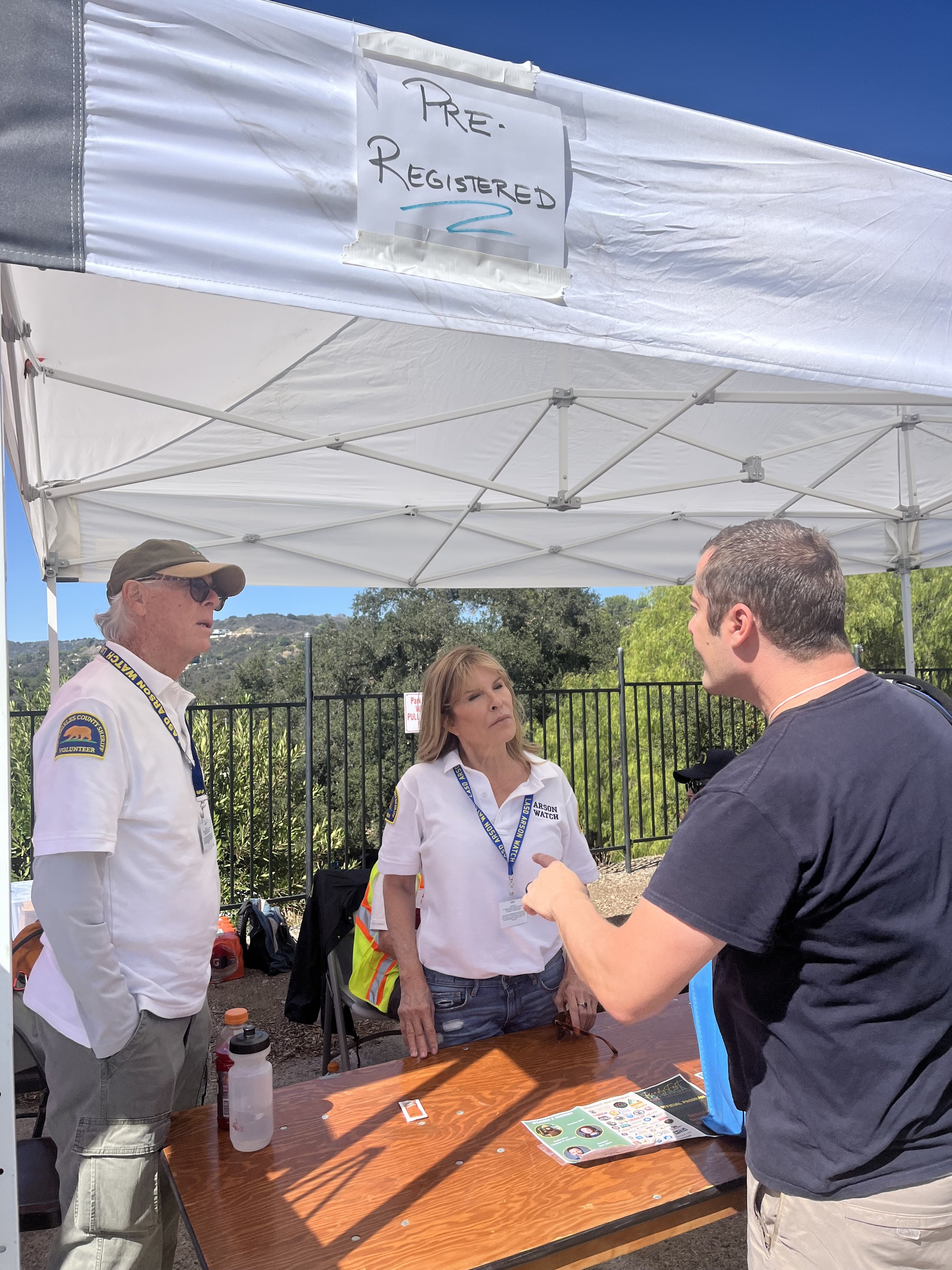 Arson Watch volunteers speaking with a resident at a  community safety fair