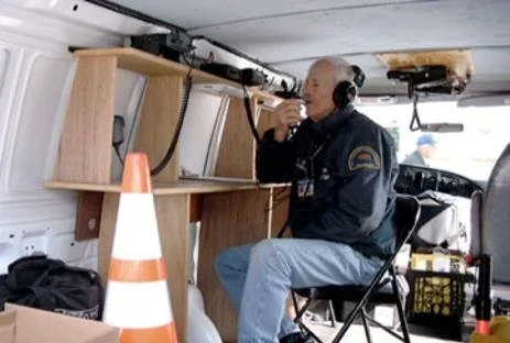 Historic image from the 1980s with Arson Watch co-founder Allen Emerson on duty in a van