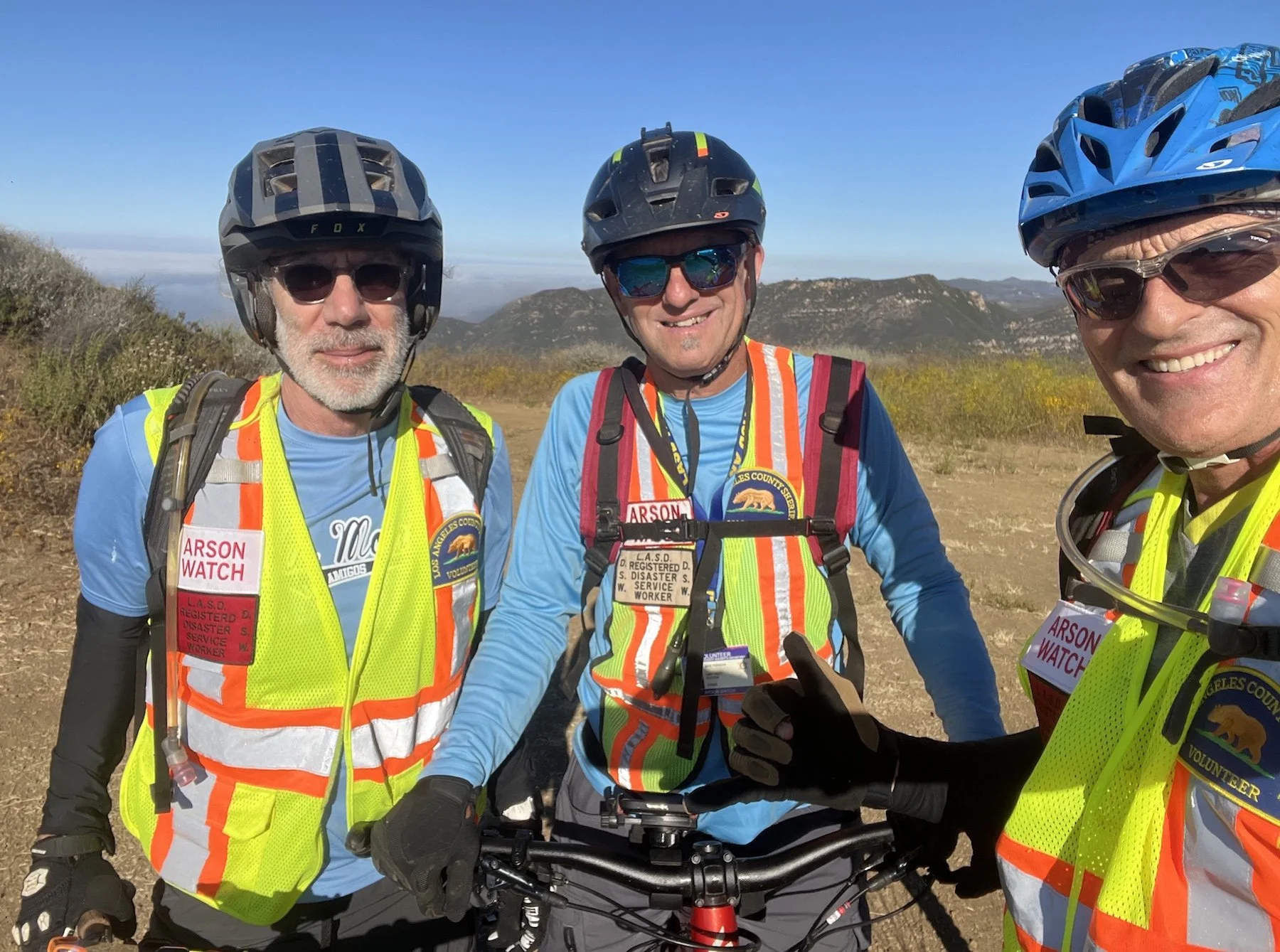 Three Arson Watch members patrolling on mountain bikes