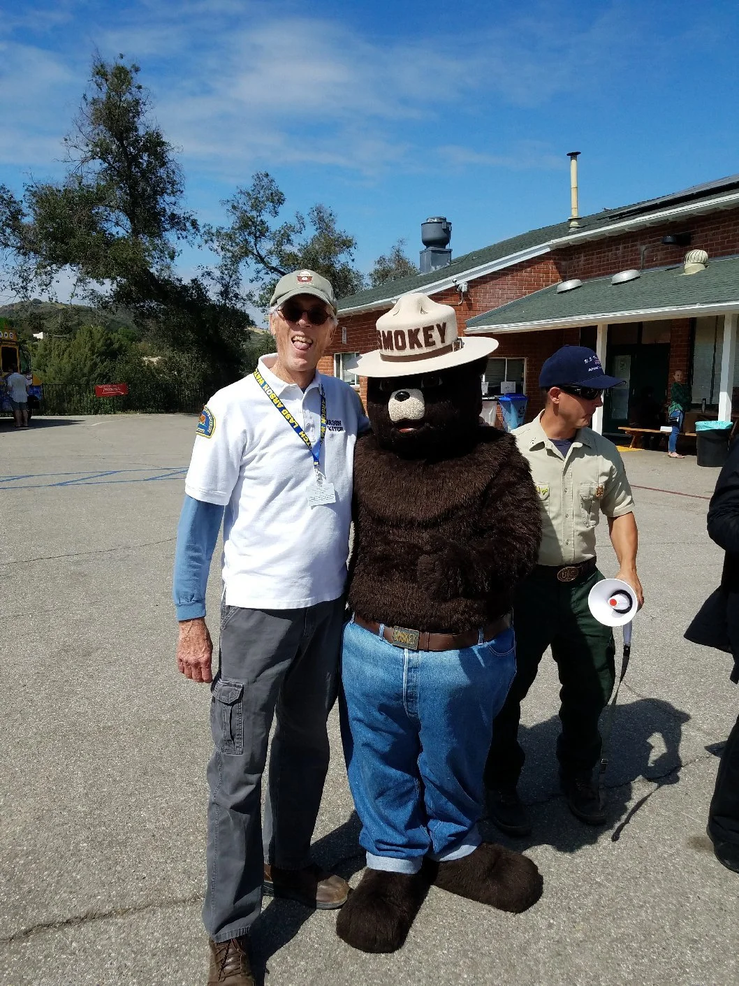 Arson Watch member standing with Smokey the Bear at a safety fair
